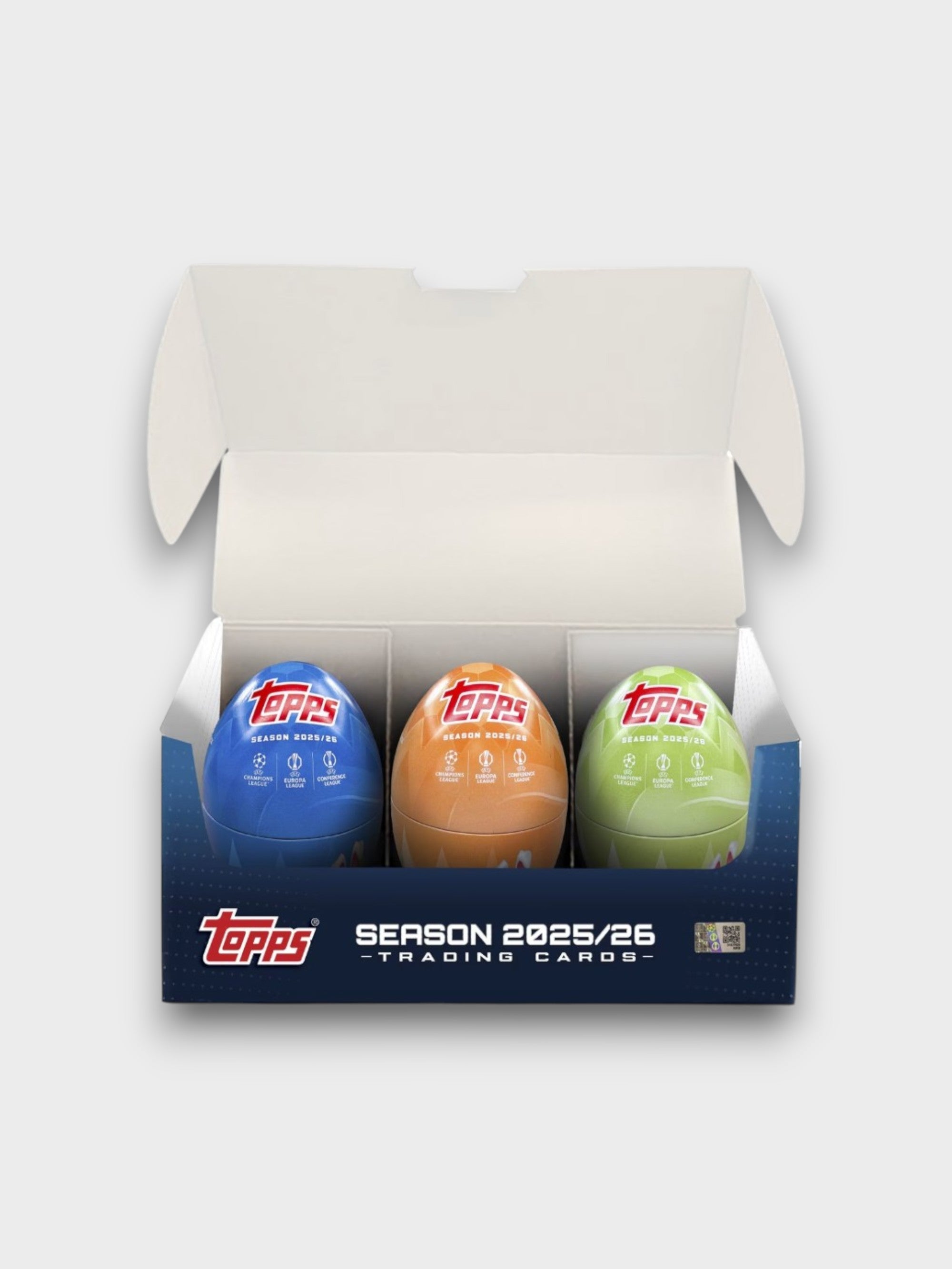 Boîte ouverte Topps Season 2025/26 Trading Cards contenant 3 œufs surprise en bleu, orange et vert, photo produit sur fond