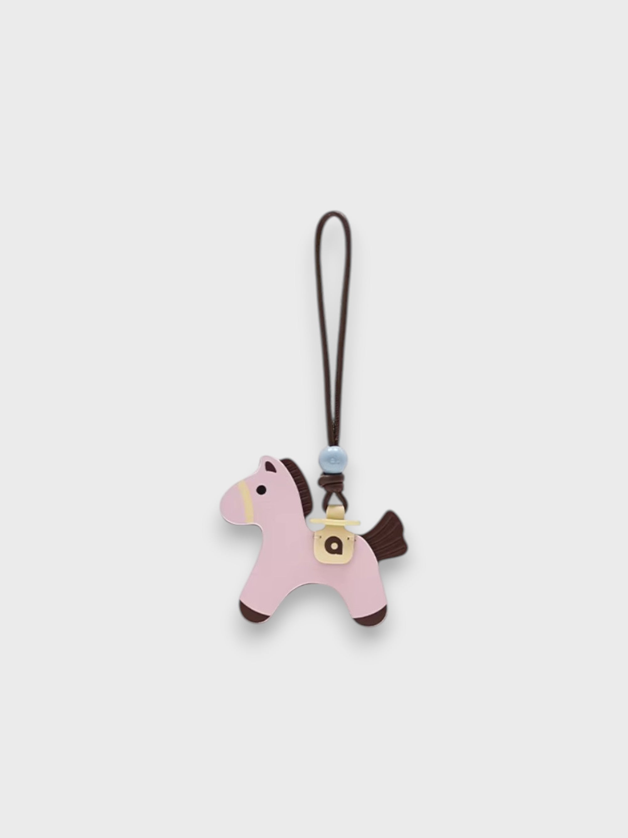 Breloque de sac Poney Sandwich MUVA rose sur fond gris clair