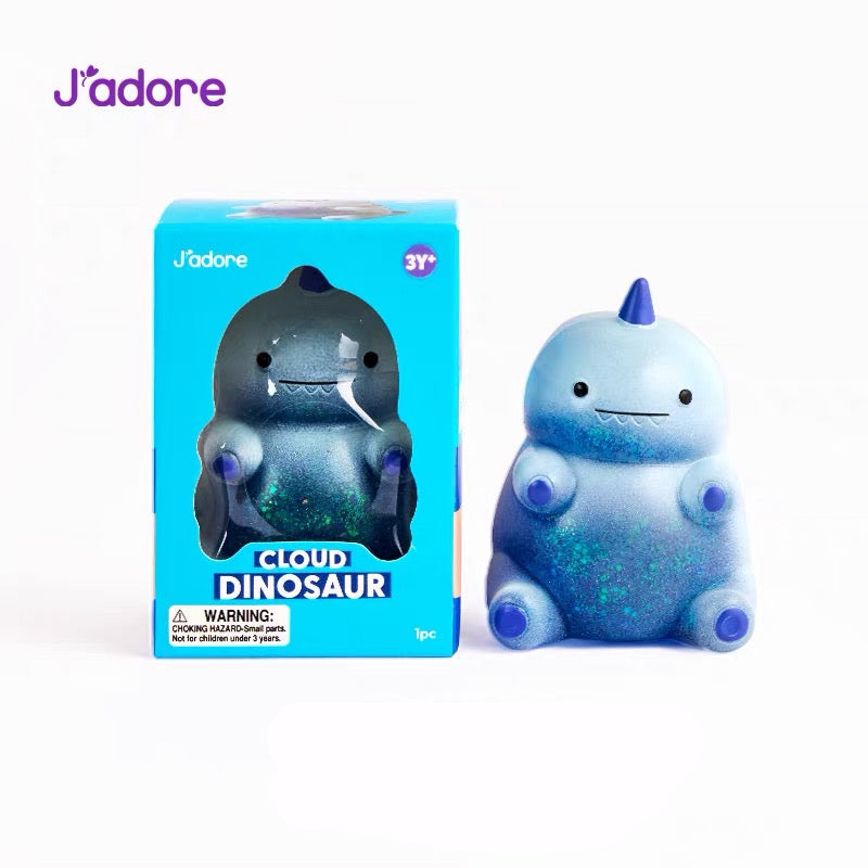 Figurine squishy J'adore Cloud Dinosaur bleu pailleté avec sa boîte d'emballage, photo produit sur fond blanc
