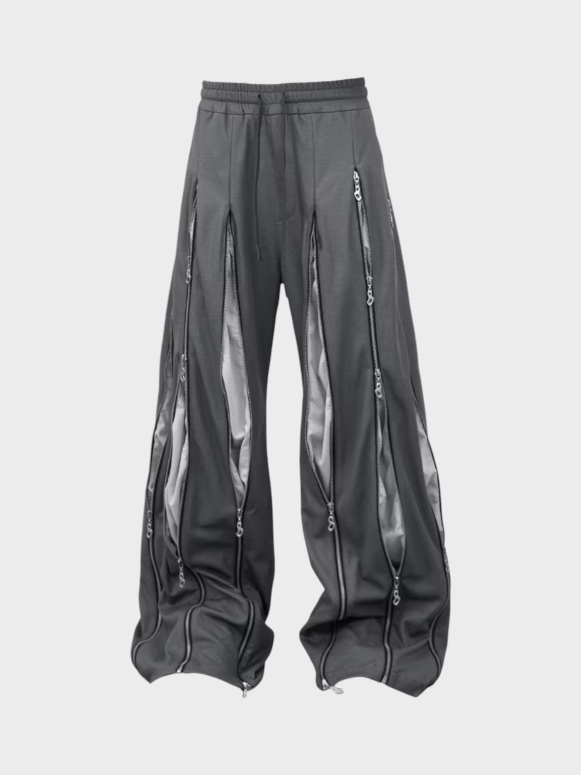 Pantalon RELABEL gris large à multiples zips et empiècements transparents en organza, vue de face sur fond gris
