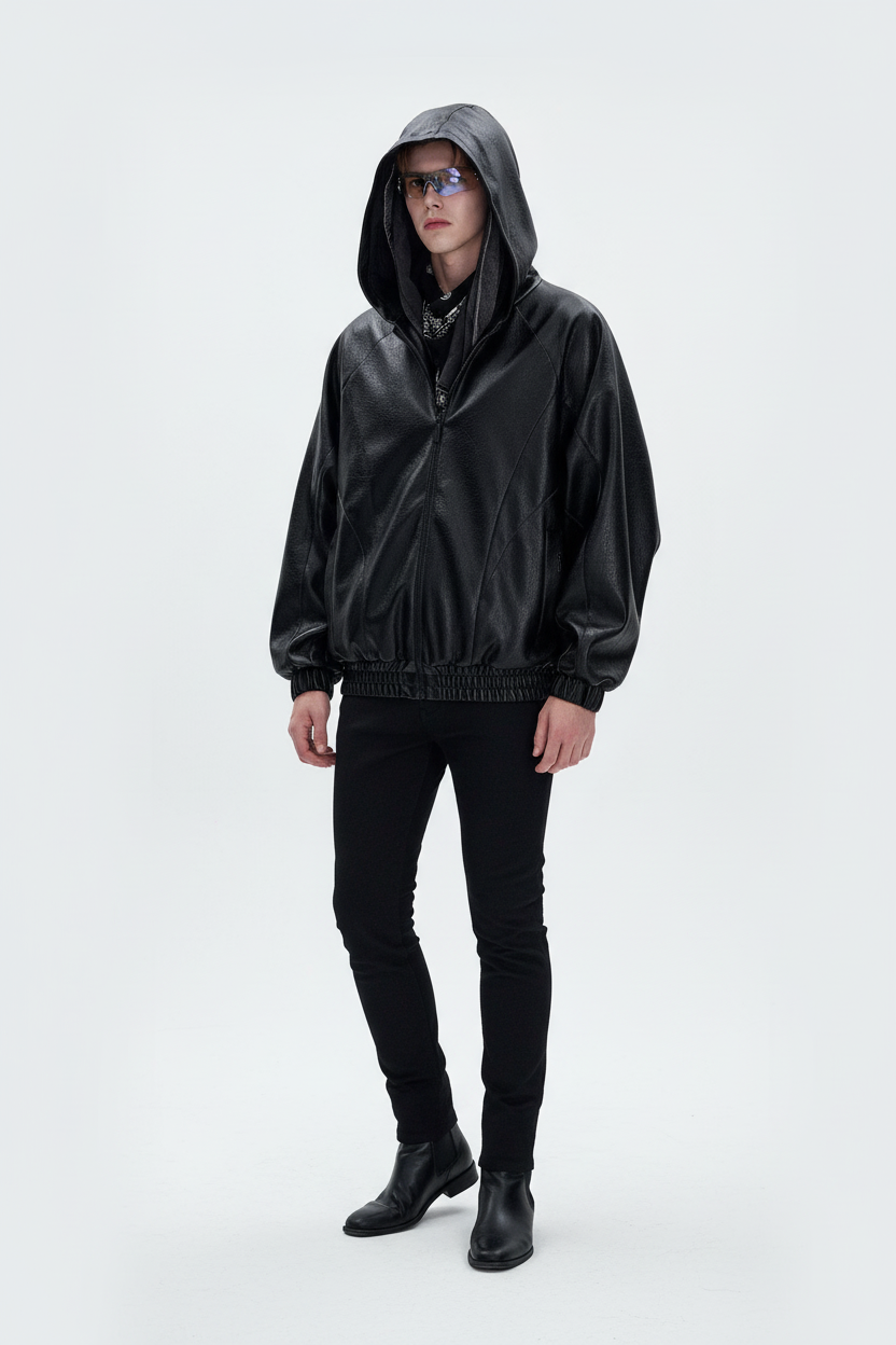 Veste BJHG noir en cuir oversize à capuche, portée par un homme avec lunettes, vue de face sur fond blanc
