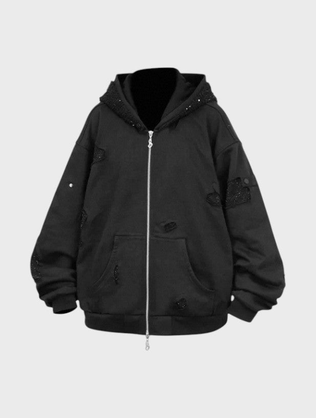 Hoodie zip oversize RELABEL noir avec incrustations strass noirs sur capuche et manches, fermeture éclair argentée et poches kangourou, vue de face
