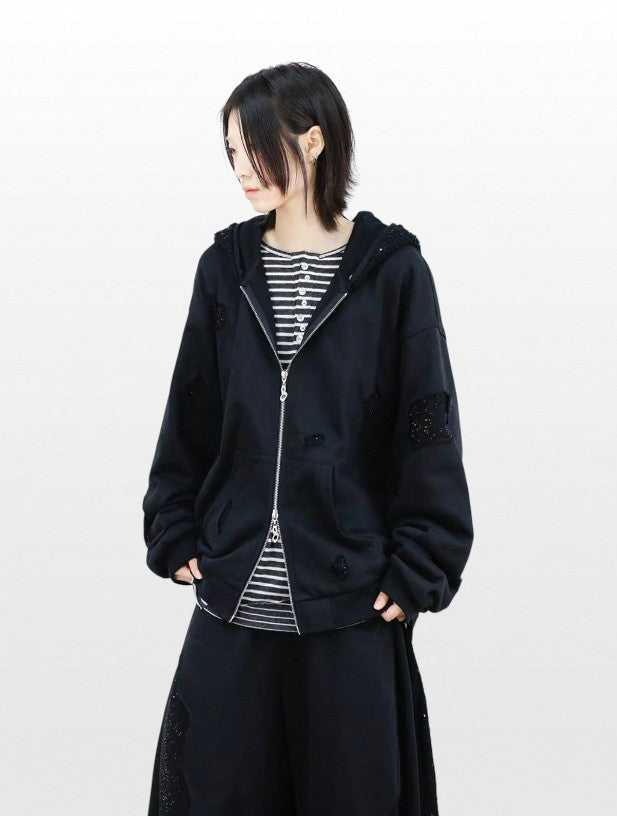 Hoodie zip oversize RELABEL noir strass porté par une femme, vue de face ouvert sur t-shirt rayé noir blanc, avec jupe large noire
