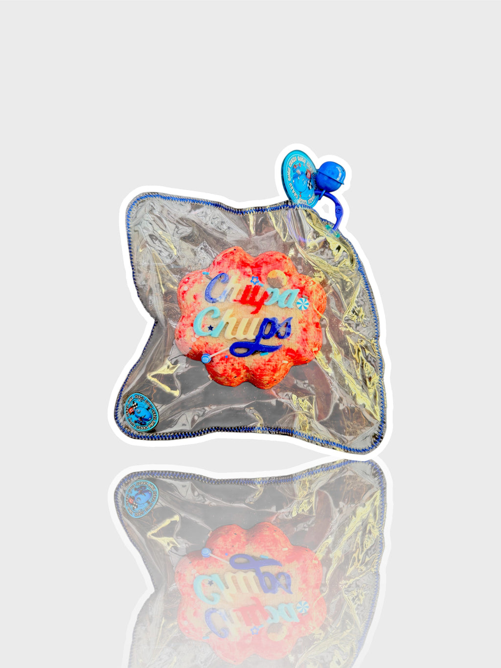 Jouet squishy mousse souple Crazy Gugu rouge et rose polyuréthane logo Chupa Chups, vue de face dans emballage holographique fond blanc