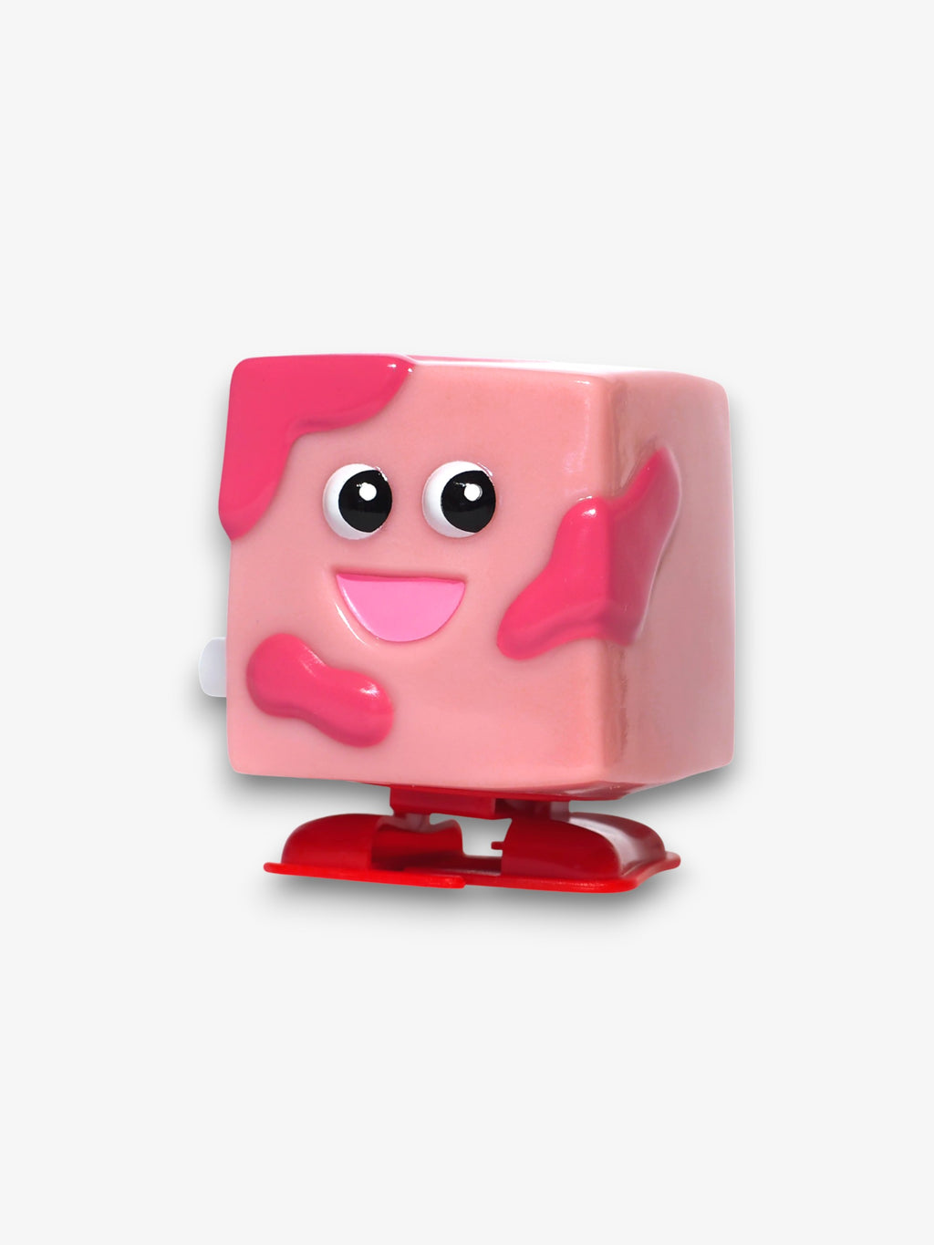 Leetoy figurine cube souriant rose – personnage cube rose avec taches foncées, grands yeux ronds, bouche souriante, pieds rouges, fond blanc
