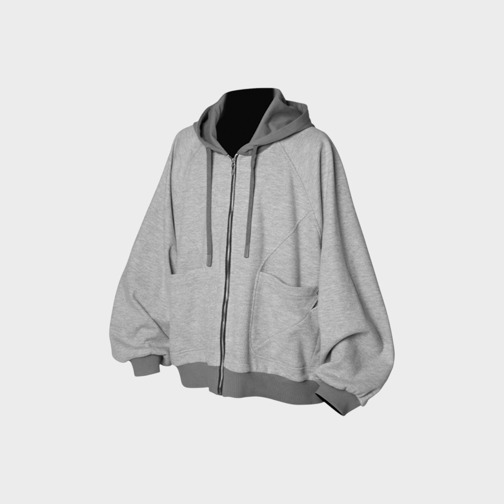Sweat à capuche zippé oversize Relabel gris chiné en coton molleton, vue de face sur mannequin fond gris, détail zip et poches kangourou