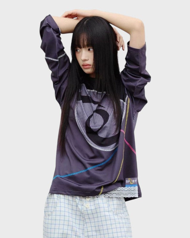 T-shirt manches longues motif spirale et coutures colorées en violet foncé, porté par une femme, vue de face
